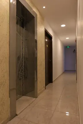 a hallway with a glass door in a building at Weekend Hotel in Aqaba