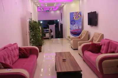a living room with purple couches and a coffee table at Weekend Hotel in Aqaba