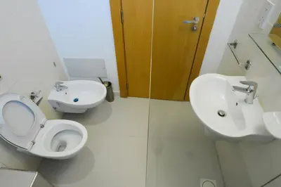 a bathroom with a toilet and a sink at Burda 41 Hotel & Suites in Amman
