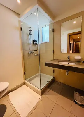 a bathroom with a shower and a sink at Burda 41 Hotel & Suites in Amman