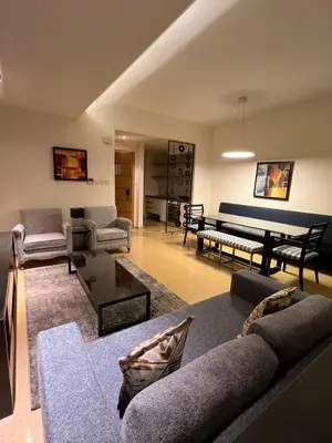 a living room with a couch and a table at Burda 41 Hotel & Suites in Amman