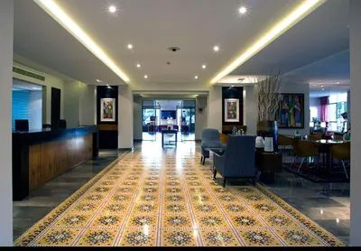 a lobby with chairs and a rug on the floor at Burda 41 Hotel & Suites in Amman