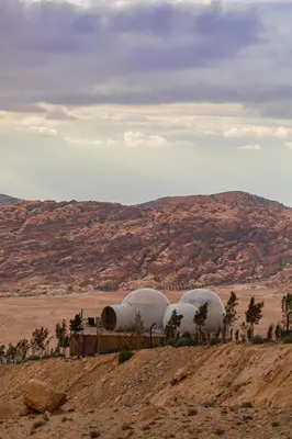 three domes sitting on top of a hill in the desert at Petra Bubble Luxotel in Wadi Musa