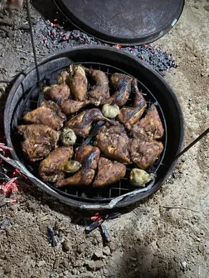a bunch of meat cooking on a grill at Ein lahda camp-site in Dana