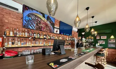 a bar at a restaurant with alcohol bottles on the wall at Petra Palace Hotel in Wadi Musa