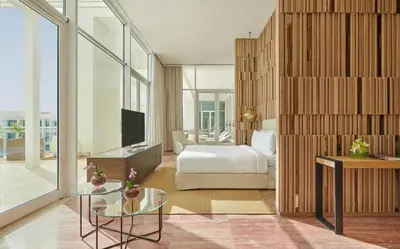 a hotel room with a bed and a television at Hyatt Regency Aqaba Ayla Resort in Aqaba