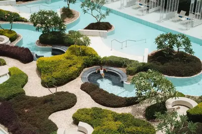 an overhead view of a pool with trees and bushes at Hyatt Regency Aqaba Ayla Resort in Aqaba