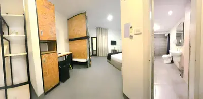 a hotel room with a bed and a bathroom at Nomads Hotel in Amman
