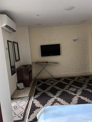 a room with a tv on the wall at Robou Al Sharq in Amman