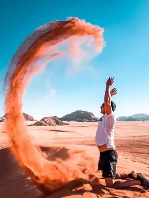 a man is standing in the desert with a large object at Bedouin Holidays Camp and Jeep Tours in Wadi Rum
