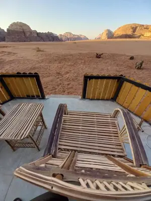 a bed sitting on a table in the desert at Bedouin Holidays Camp and Jeep Tours in Wadi Rum