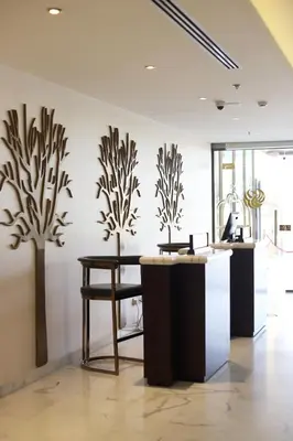 a room with a table and some plants on the wall at The SanRock Hotel in Amman