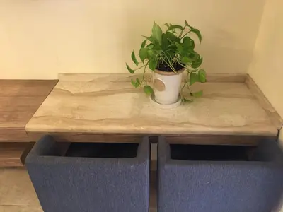 a potted plant sitting on top of a wooden table at Royal Luxury Apartments & Studios in Amman