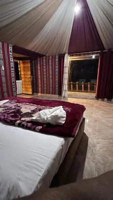 a bedroom with a bed in a tent at Miral Night Camp in Wadi Rum