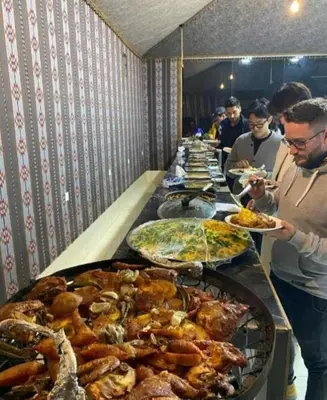 a buffet line with many different types of food at Miral Night Camp in Wadi Rum
