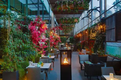 a restaurant with tables and flowers in a building at Hilton Amman in Amman