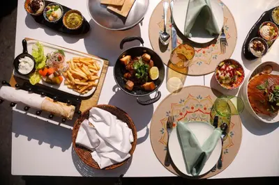 a table with many plates of food on it at Hilton Amman in Amman