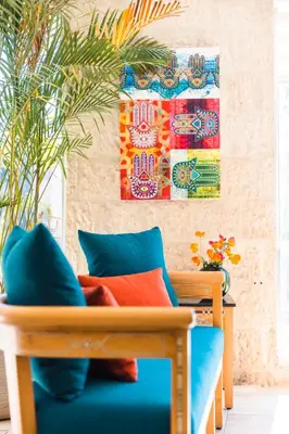 a living room with a couch and a painting on the wall at The Liwan Hotel in Amman