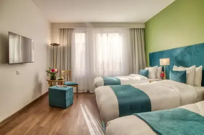 a hotel room with two beds with blue and white at The Liwan Hotel in Amman