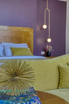 a bedroom with a bed and a table with a fan on it at The Liwan Hotel in Amman