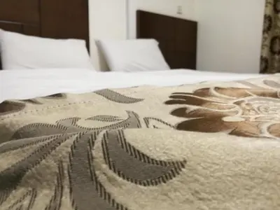 a bed with a blanket with a design on it at Darak hotel in Aqaba
