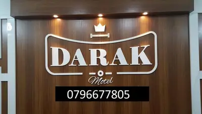 a sign for a car dealership on a wooden wall at Darak hotel in Aqaba
