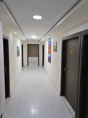 a hallway with two doors and a tile floor at Darak hotel in Aqaba