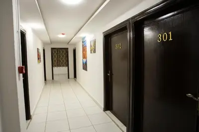 a hallway with black doors and a tile floor at Darak hotel in Aqaba