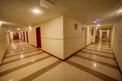 an empty hallway in an office building at Crystal Hotel By FHM in Aqaba