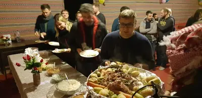 a group of people standing around a table with food at Real Bedouin Experience Tours & Camp in Wadi Rum