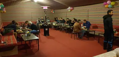 a group of people sitting at tables in a room at Real Bedouin Experience Tours & Camp in Wadi Rum