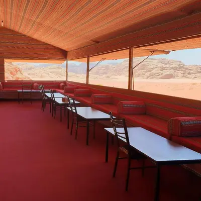 a row of tables and chairs in a restaurant at Real Bedouin Experience Tours & Camp in Wadi Rum