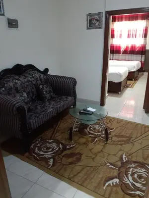 a living room with a couch and a table at Petra Visitors Hotel in Wadi Musa