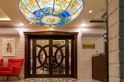 a lobby with a stained glass ceiling at Petra Boutique Hotel in Wadi Musa