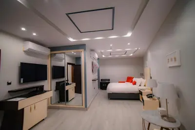 a hotel room with a bed and a television at Petra Boutique Hotel in Wadi Musa
