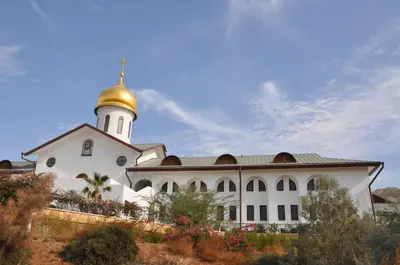 a large white building with a gold dome on top at Russian Pilgrim Residence in Sowayma