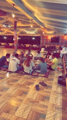 a group of people sitting on the floor in a tent at Wadi Rum Bubble Camp in Wadi Rum