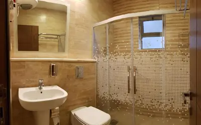 a bathroom with a sink and a toilet and a shower at Marmaris Hotel Apartments in Amman