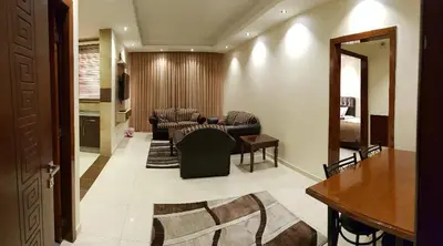 a living room with a couch and chairs in a room at Marmaris Hotel Apartments in Amman