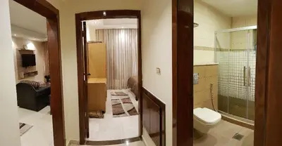 a bathroom with a shower and a toilet in a room at Marmaris Hotel Apartments in Amman