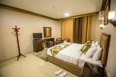 a hotel room with a bed and a television at Grape Village Hotel in Amman