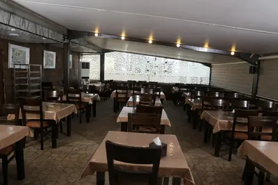 a dining room filled with tables and chairs at Grape Village Hotel in Amman