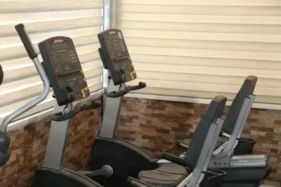 a row of cardio machines in a gym at Grape Village Hotel in Amman