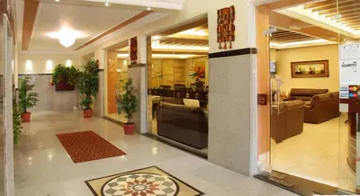 a lobby of a building with a large glass door at Jardaneh Hotel in Aqaba