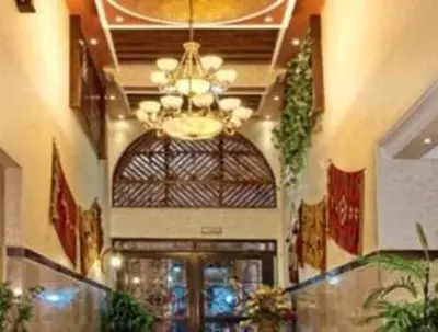 a lobby with a chandelier and a building at Jardaneh Hotel in Aqaba