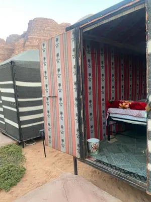 a container with a bed in it in the desert at Bedouin Village Hostel in Wadi Rum