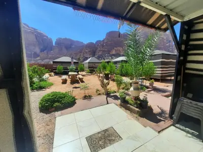 a view of a patio with mountains in the background at Bedouin Village Hostel in Wadi Rum