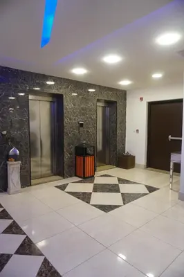 a lobby with black and white checkered floor at Skylight apartments in Amman