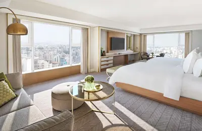 a hotel room with a bed and a couch at Four Seasons Hotel Amman in Amman