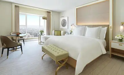 a hotel room with a large bed and a desk at Four Seasons Hotel Amman in Amman